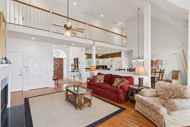 505 E Arctic Ave, Folly Beach, SC 29439 - living area featuring ceiling fan, a high ceiling, wood finished floors, a fireplace with flush hearth, and recessed lighting