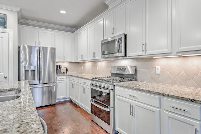 kitchen with white cabinetry, light stone countertops, and appliances with stainless steel finishes