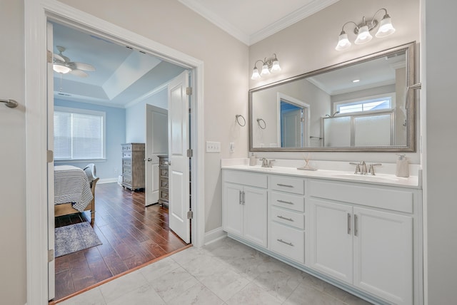bathroom featuring crown molding, wood-type flooring, vanity, and ceiling fan