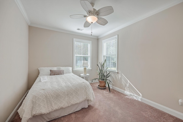 carpeted bedroom with ornamental molding and ceiling fan