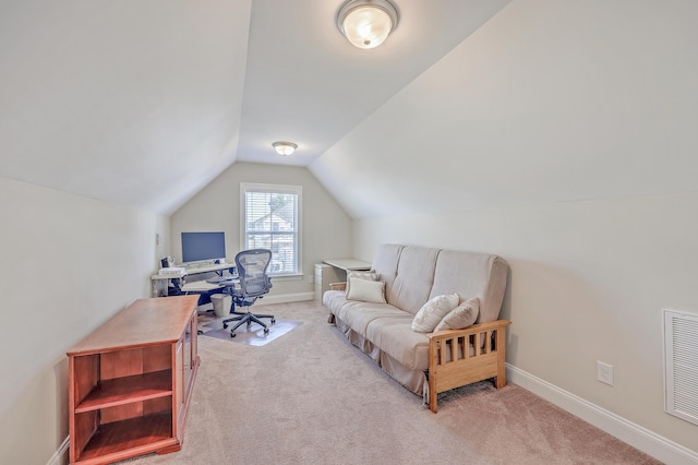 carpeted office featuring lofted ceiling