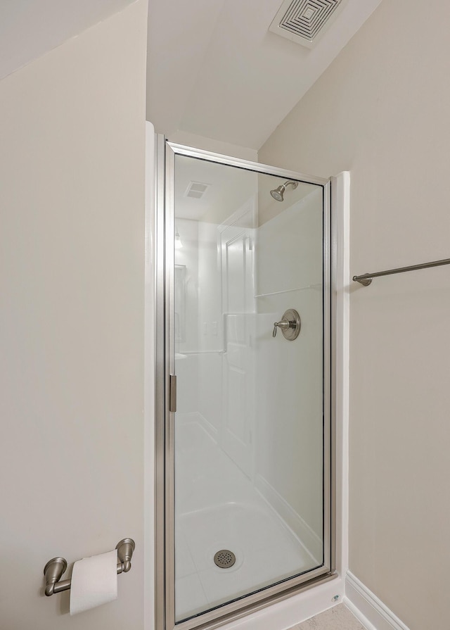 bathroom featuring a shower with shower door