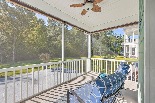 unfurnished sunroom featuring ceiling fan