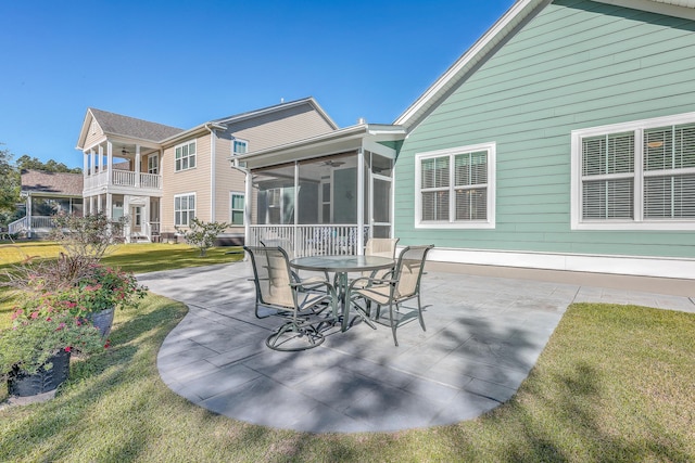 view of patio with a sunroom and ceiling fan