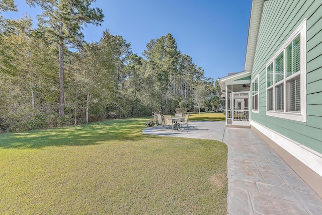 view of yard featuring a patio and ceiling fan