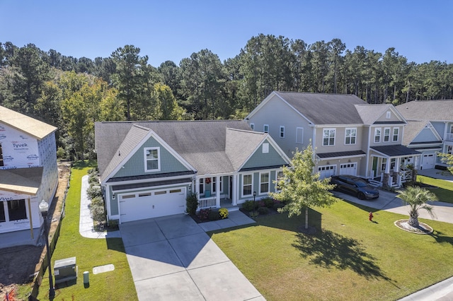 craftsman house featuring a garage, a front yard, and covered porch
