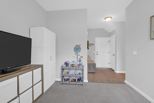 game room featuring carpet floors, baseboards, and lofted ceiling