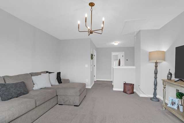 carpeted living area with baseboards and attic access