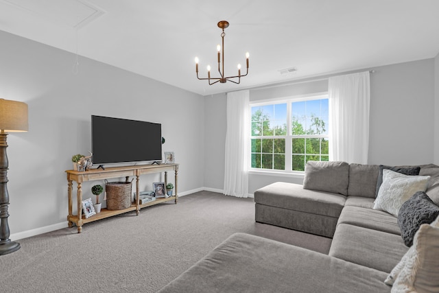 carpeted living area with baseboards, a notable chandelier, attic access, and visible vents