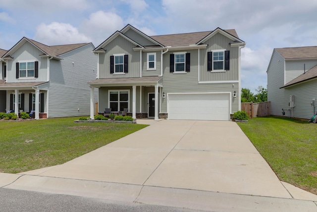 view of front of property featuring a garage, a front lawn, fence, board and batten siding, and concrete driveway