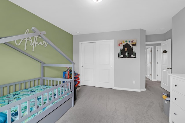 bedroom with carpet flooring, baseboards, and a closet