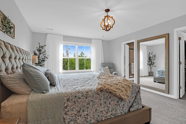 carpeted bedroom with an inviting chandelier and visible vents
