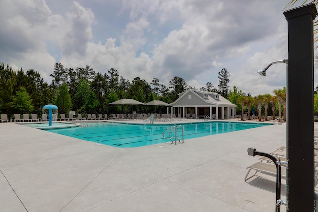 pool featuring fence and a patio area