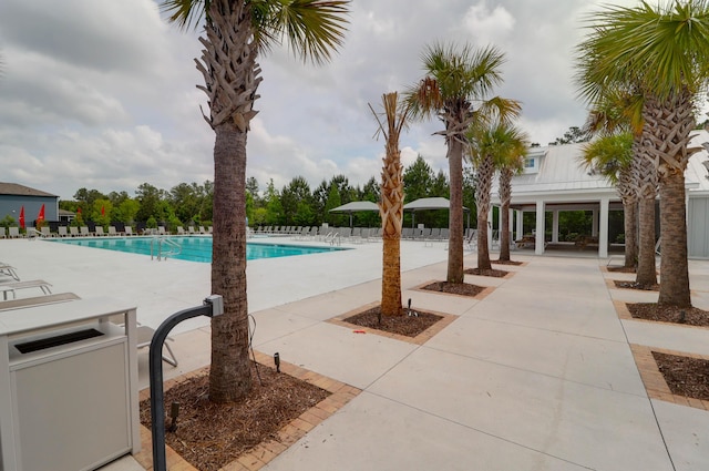 community pool featuring a patio and fence