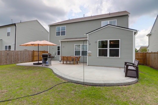 rear view of house featuring a fenced backyard, a patio area, and a yard