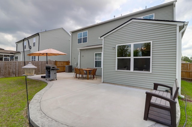 back of property with a patio area, fence, a yard, and cooling unit
