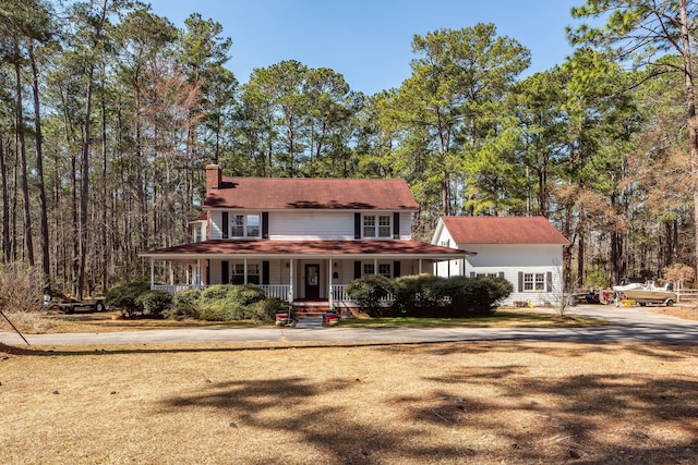 view of front of property with a porch and a chimney