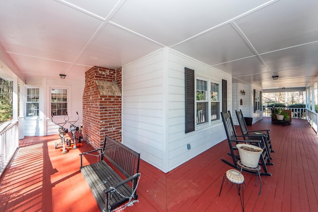 wooden terrace featuring covered porch