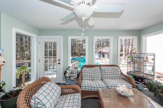 sunroom featuring ceiling fan