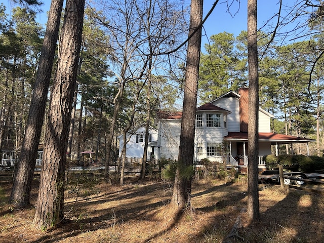 exterior space featuring a porch and a chimney