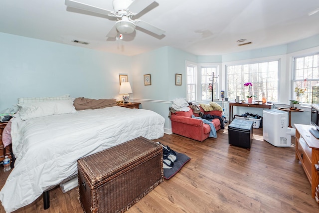 bedroom featuring visible vents, ceiling fan, and wood finished floors