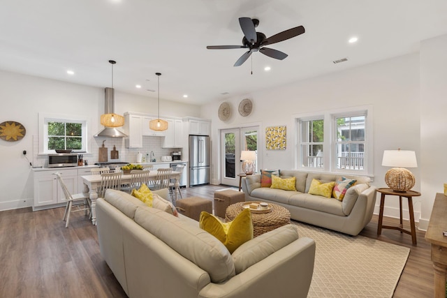 living room with recessed lighting, visible vents, plenty of natural light, and wood finished floors