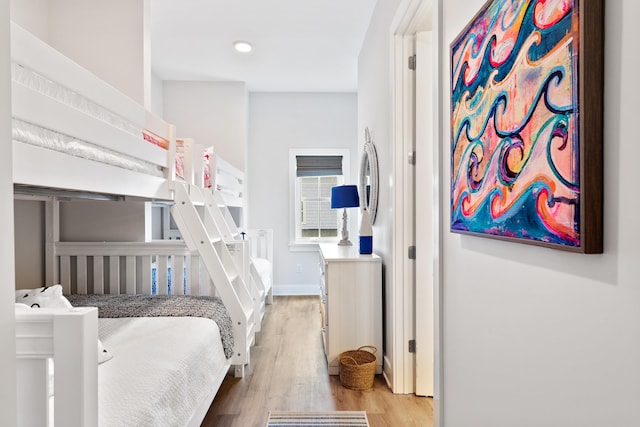 bedroom featuring wood finished floors and baseboards