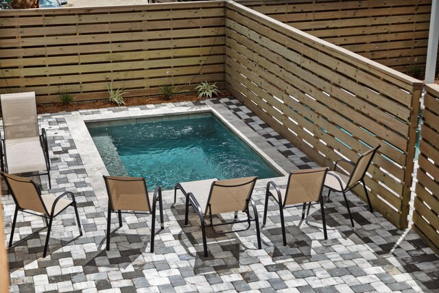 view of pool featuring a pool, a patio, and fence