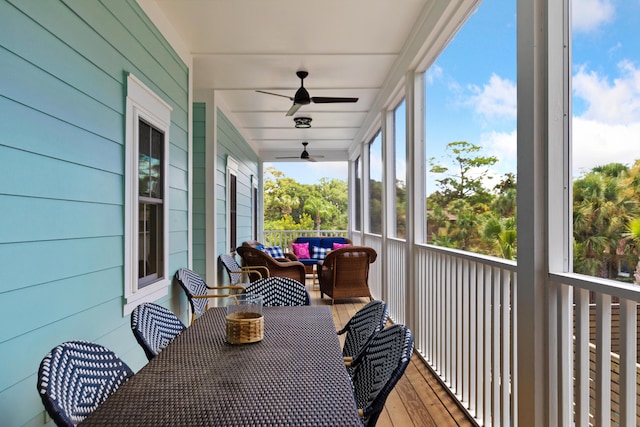 sunroom featuring ceiling fan