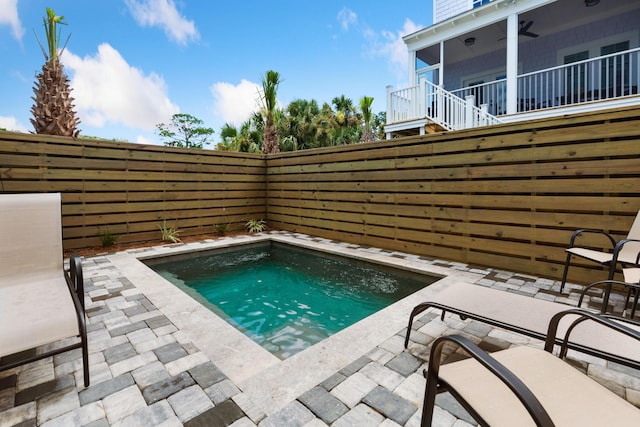 view of swimming pool with a fenced backyard, stairs, and a patio area