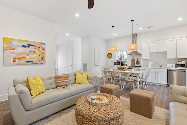 living area with light wood-style flooring, recessed lighting, visible vents, and baseboards