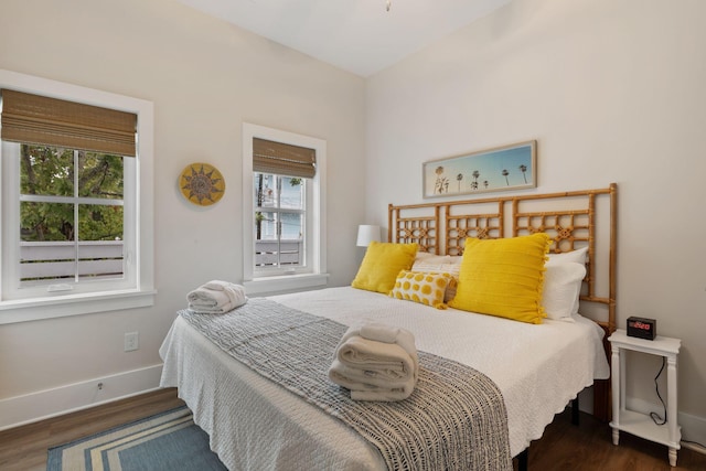 bedroom featuring wood finished floors and baseboards