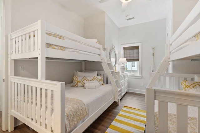 bedroom with visible vents, a ceiling fan, baseboards, and wood finished floors