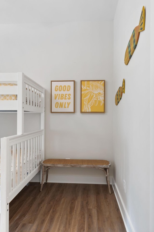 bedroom with baseboards and wood finished floors