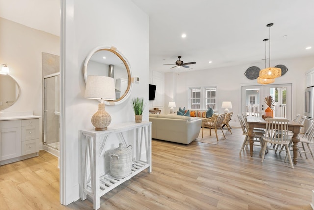 living area featuring recessed lighting, light wood-type flooring, and a ceiling fan