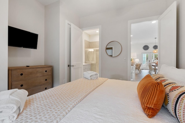 bedroom featuring ensuite bath and recessed lighting