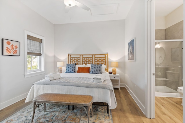 bedroom featuring connected bathroom, baseboards, and light wood-style flooring