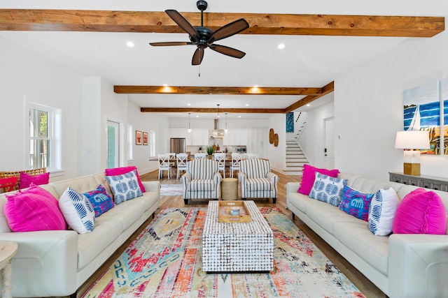 living room with recessed lighting, beamed ceiling, wood finished floors, and stairway