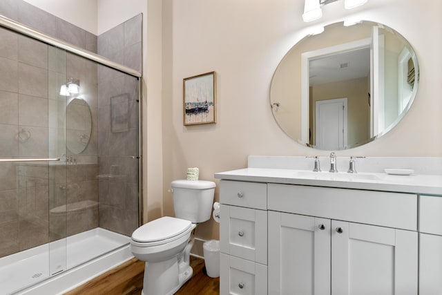 full bathroom with vanity, toilet, wood finished floors, and a shower stall