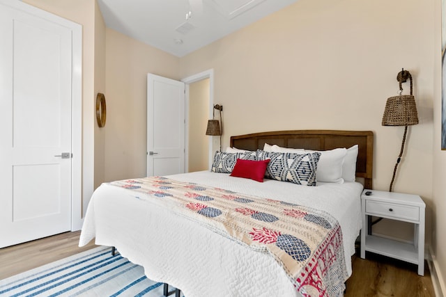 bedroom featuring visible vents and wood finished floors