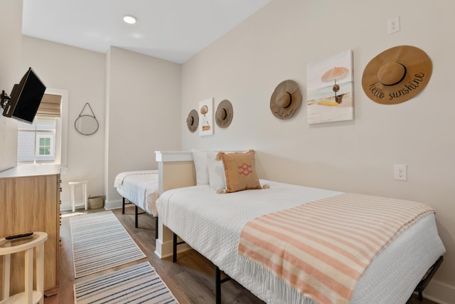 bedroom with recessed lighting, baseboards, and wood finished floors