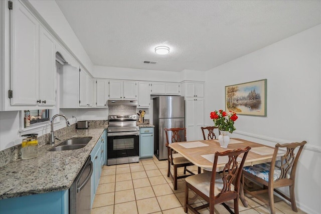 58 Indigo Ln, Goose Creek, SC 29445 - kitchen with appliances with stainless steel finishes, a sink, under cabinet range hood, blue cabinetry, and white cabinetry