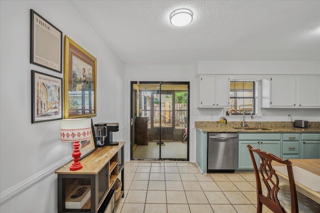 58 Indigo Ln, Goose Creek, SC 29445 - kitchen featuring stainless steel dishwasher, a sink, a textured ceiling, white cabinets, and light tile patterned flooring