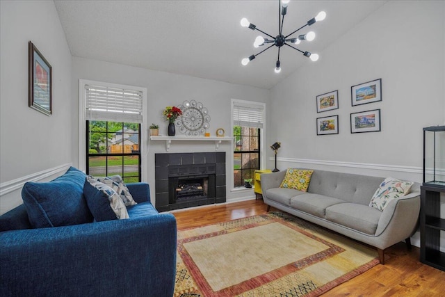 58 Indigo Ln, Goose Creek, SC 29445 - living room with lofted ceiling, healthy amount of natural light, wood finished floors, a chandelier, and a fireplace