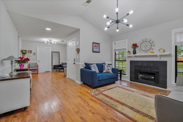 58 Indigo Ln, Goose Creek, SC 29445 - living room with a chandelier, hardwood / wood-style floors, vaulted ceiling, and a fireplace
