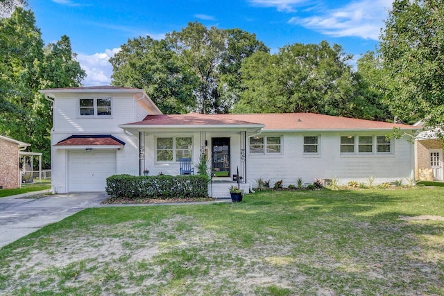 split level home with a porch, a garage, brick siding, driveway, and a front lawn