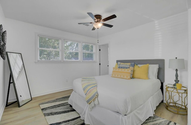 bedroom featuring light wood-type flooring, ceiling fan, and baseboards