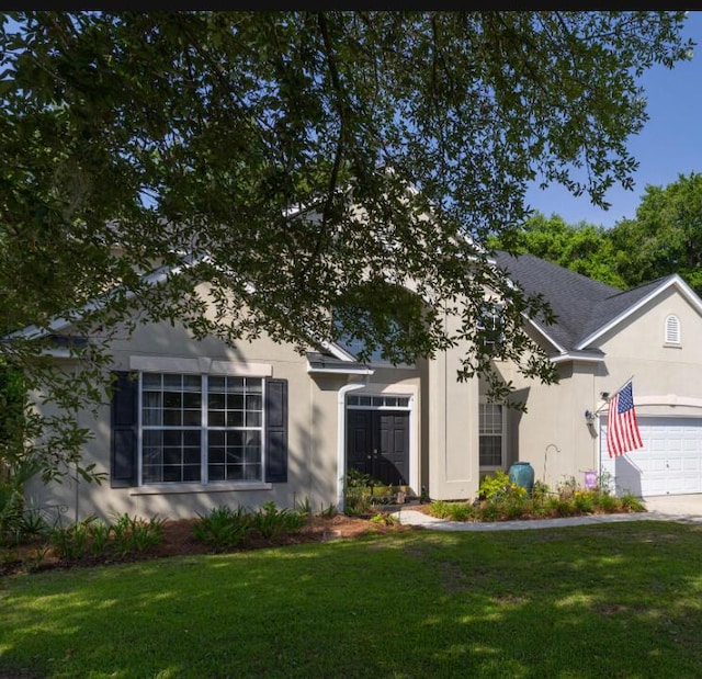 6242 Fieldstone Cir, Charleston, SC 29414 - view of front of home with stucco siding, a front yard, and an attached garage