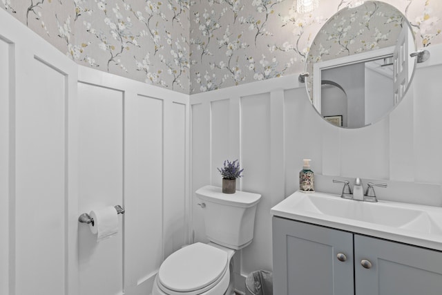 6242 Fieldstone Cir, Charleston, SC 29414 - half bathroom featuring wallpapered walls, a wainscoted wall, toilet, vanity, and a decorative wall
