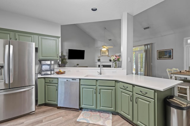 6242 Fieldstone Cir, Charleston, SC 29414 - kitchen featuring stainless steel appliances, green cabinetry, a sink, light wood-style floors, and lofted ceiling